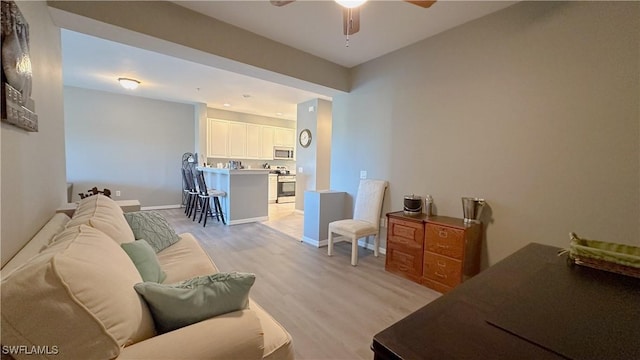 14512 Abaco Lakes Dr Unit 103, Fort Myers, FL 33908 - living area with baseboards, light wood-type flooring, and ceiling fan