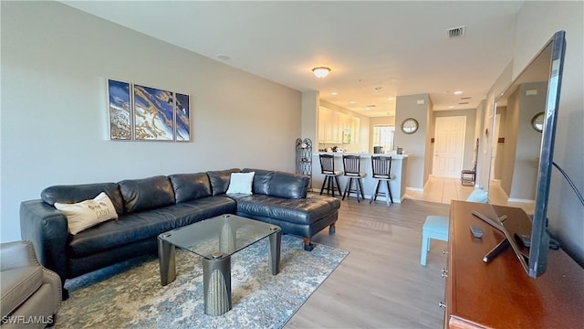 14512 Abaco Lakes Dr Unit 103, Fort Myers, FL 33908 - living room featuring light wood finished floors, baseboards, and visible vents