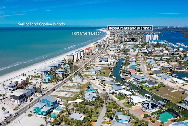 drone / aerial view with a water view and a beach view