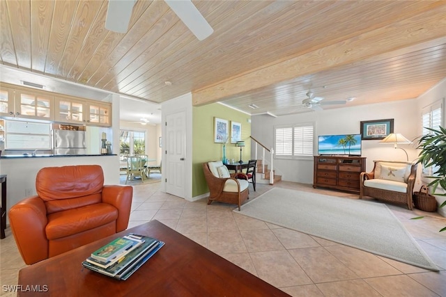 living area with light tile patterned floors, wood ceiling, stairway, and a ceiling fan