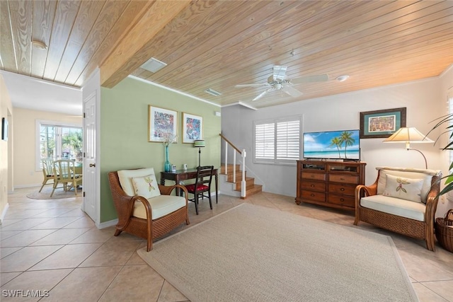 living area featuring light tile patterned floors, wooden ceiling, crown molding, and stairs