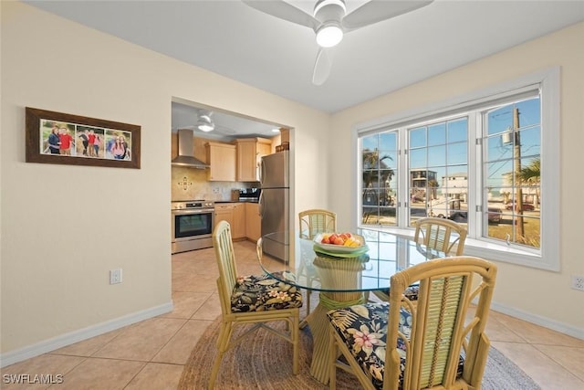 dining area featuring a ceiling fan, light tile patterned floors, and baseboards