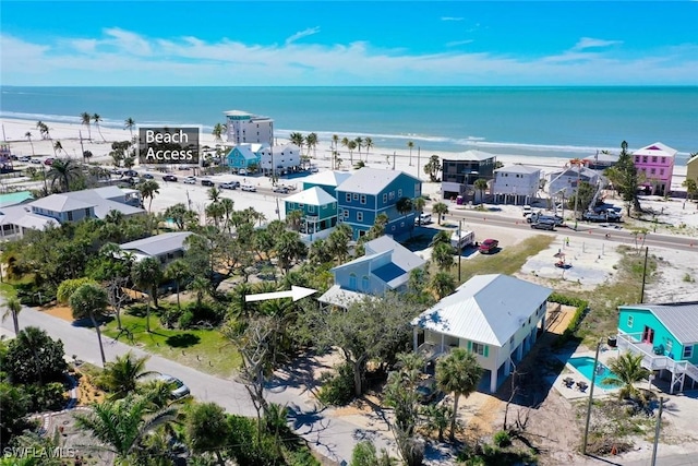birds eye view of property featuring a water view and a view of the beach