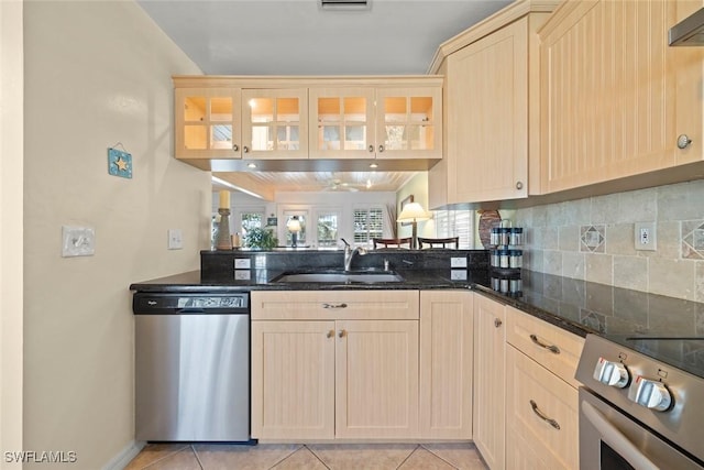 kitchen featuring light brown cabinets, a sink, and stainless steel appliances