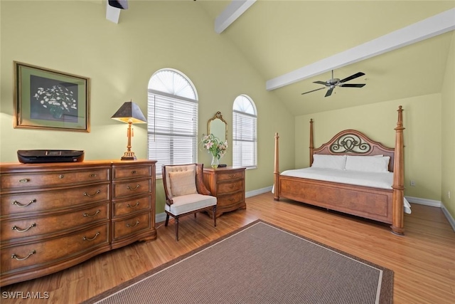 bedroom with a ceiling fan, baseboards, beamed ceiling, and wood finished floors
