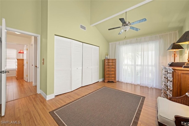 bedroom featuring multiple windows, visible vents, a closet, and light wood-style flooring