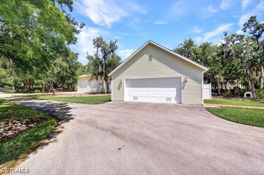 17150 Scout Camp Rd, Alva, FL 33920 - view of home's exterior featuring a garage