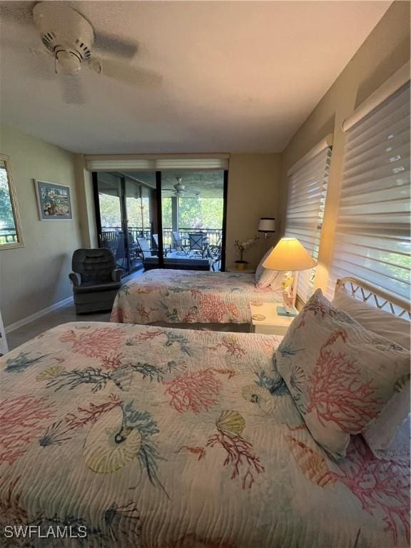 3661 Wild Pines Dr Unit 205, Bonita Springs, FL 34134 - bedroom with baseboards, multiple windows, a ceiling fan, and access to exterior