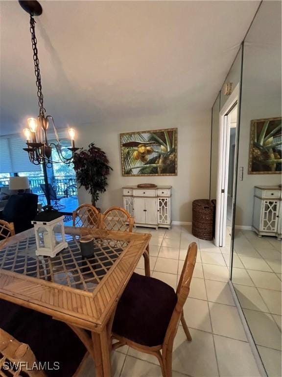 3661 Wild Pines Dr Unit 205, Bonita Springs, FL 34134 - dining space featuring light tile patterned floors, baseboards, and a chandelier
