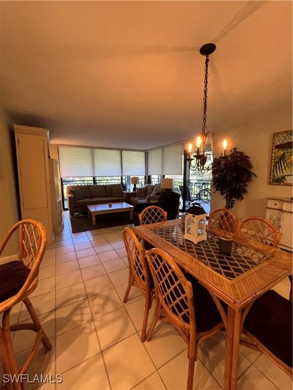 3661 Wild Pines Dr Unit 205, Bonita Springs, FL 34134 - dining area with an inviting chandelier and light tile patterned floors