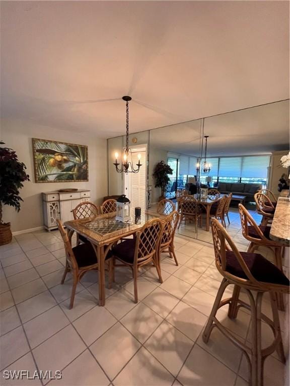 3661 Wild Pines Dr Unit 205, Bonita Springs, FL 34134 - dining area with a chandelier, baseboards, and light tile patterned floors