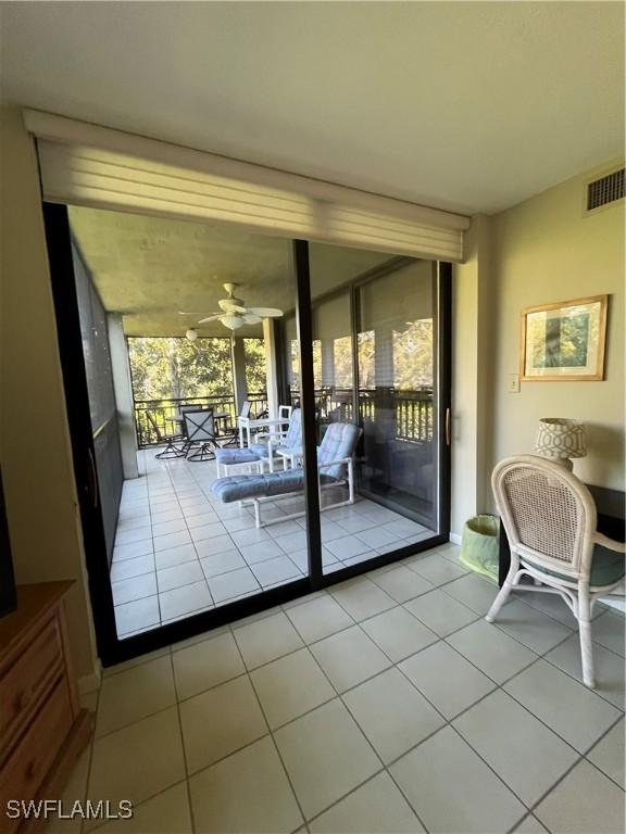 3661 Wild Pines Dr Unit 205, Bonita Springs, FL 34134 - entryway featuring light tile patterned floors, ceiling fan, visible vents, and floor to ceiling windows