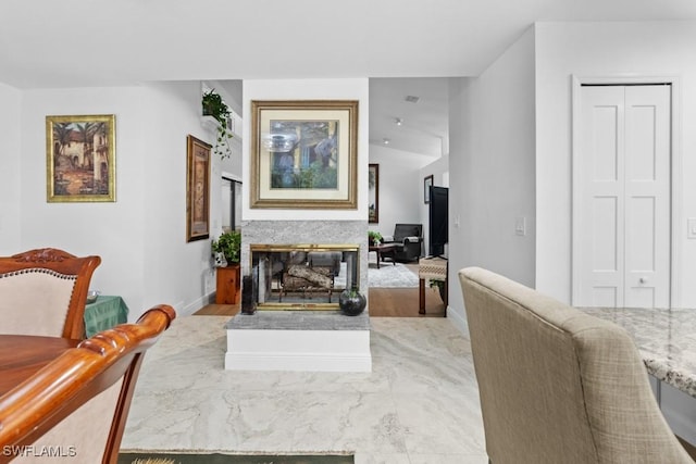 7090 Hendry Creek Dr, Fort Myers, FL 33908 - living area with light wood-style flooring, a glass covered fireplace, and baseboards