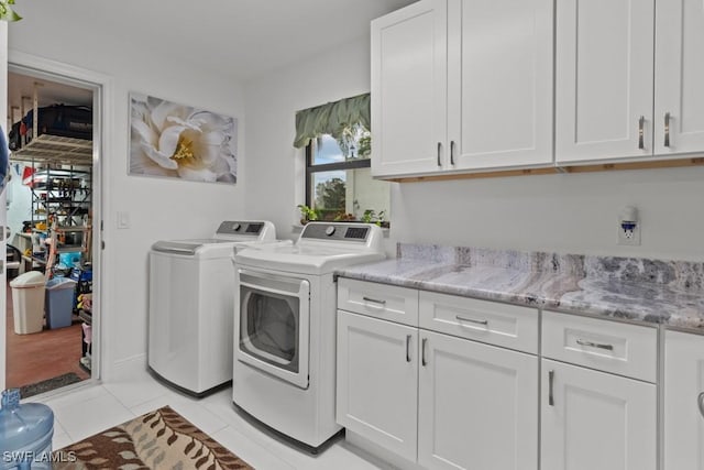7090 Hendry Creek Dr, Fort Myers, FL 33908 - clothes washing area featuring washing machine and clothes dryer, cabinet space, and light tile patterned floors