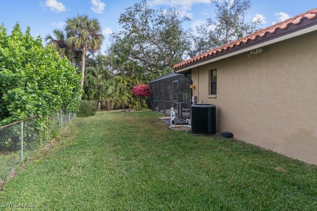 7090 Hendry Creek Dr, Fort Myers, FL 33908 - view of yard with cooling unit, a fenced backyard, and a lanai