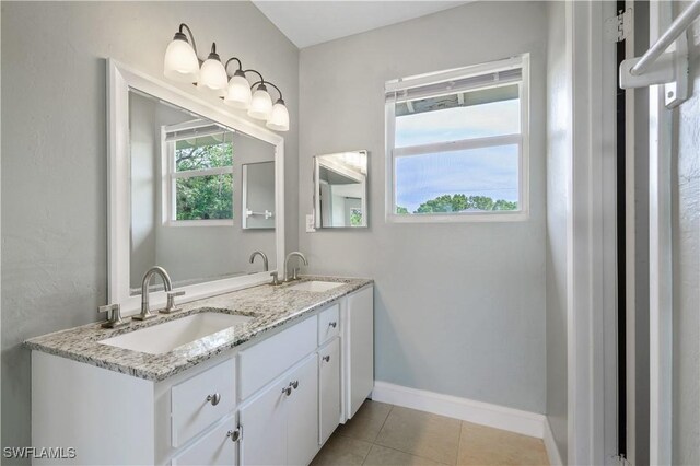 6070 Lacota Ave, Fort Myers, FL 33905 - full bathroom with baseboards, double vanity, a sink, and tile patterned floors