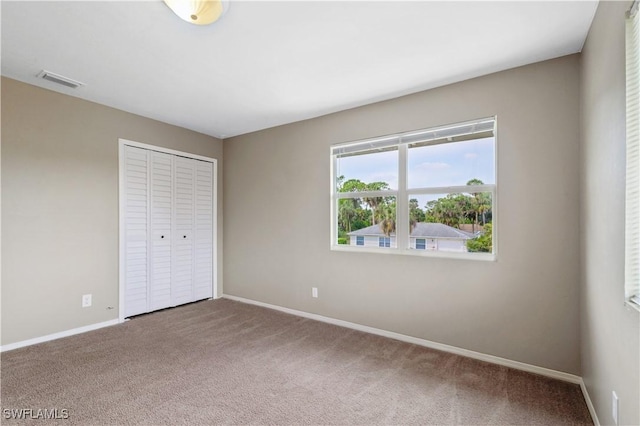6070 Lacota Ave, Fort Myers, FL 33905 - unfurnished bedroom with baseboards, visible vents, a closet, and carpet