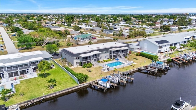birds eye view of property featuring a water view and a residential view