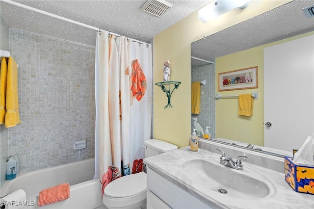 bathroom with vanity, toilet, a textured ceiling, visible vents, and shower / bath combo with shower curtain