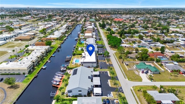 birds eye view of property with a water view and a residential view
