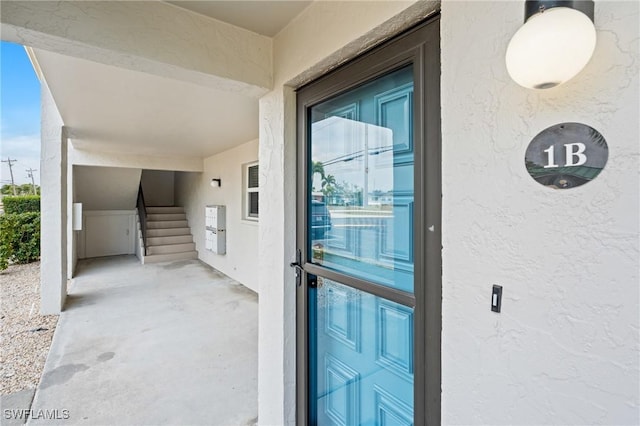 doorway to property featuring stucco siding