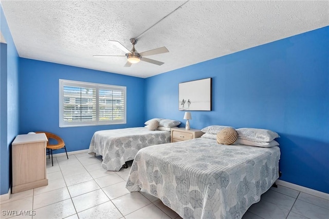 tiled bedroom with baseboards, ceiling fan, and a textured ceiling