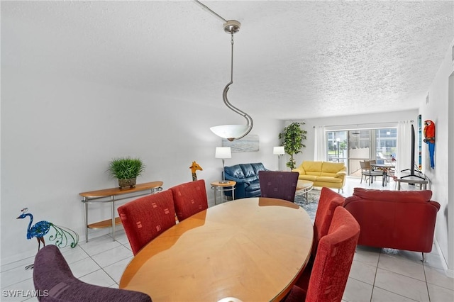 dining space featuring baseboards, tile patterned flooring, and a textured ceiling