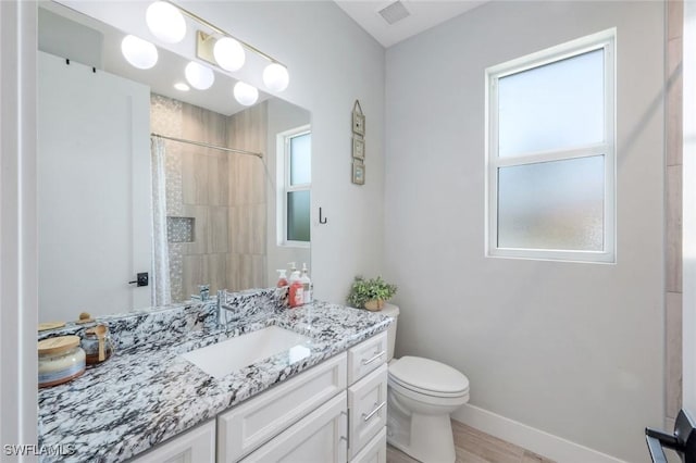 2590 Surfside Blvd, Cape Coral, FL 33914 - full bathroom with visible vents, baseboards, toilet, vanity, and tiled shower