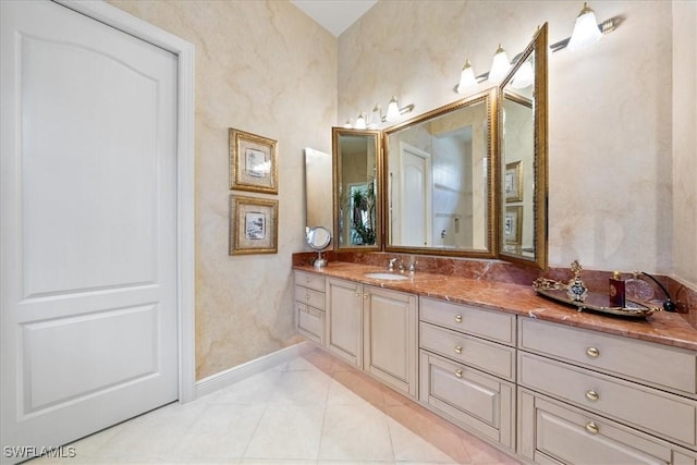 bathroom featuring baseboards and vanity
