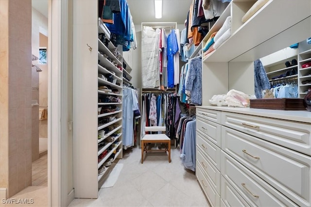 spacious closet with light tile patterned flooring