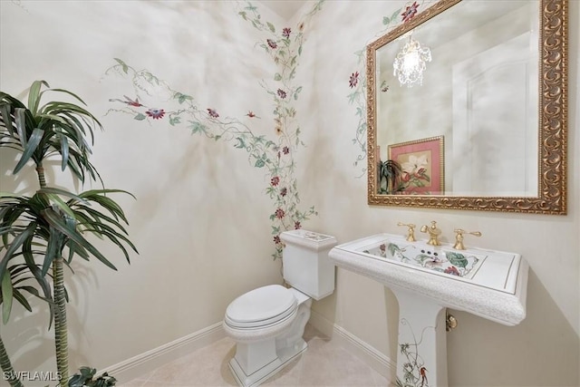 bathroom featuring toilet, tile patterned flooring, and baseboards