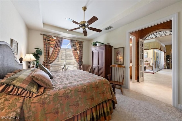 bedroom featuring light carpet, ceiling fan, and visible vents