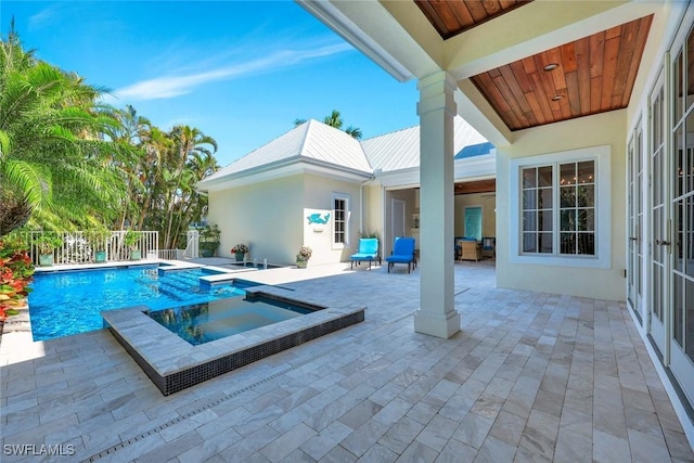 view of pool featuring a patio, an in ground hot tub, fence, and a fenced in pool
