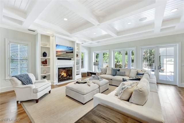 living area with plenty of natural light, coffered ceiling, and beamed ceiling