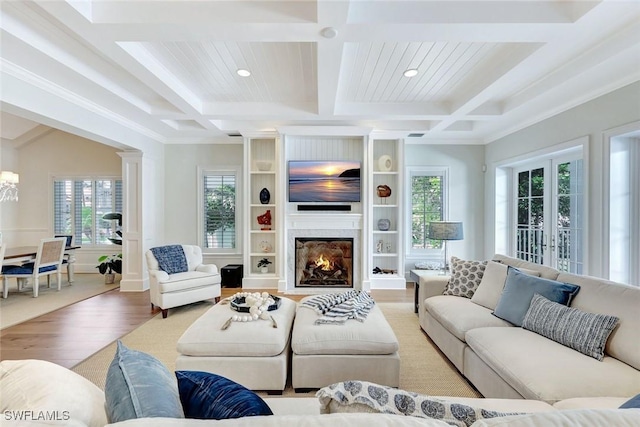 living area featuring wood finished floors, beamed ceiling, recessed lighting, a large fireplace, and coffered ceiling