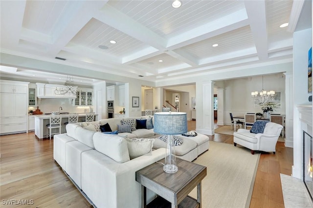 living room featuring an inviting chandelier, beamed ceiling, coffered ceiling, and recessed lighting