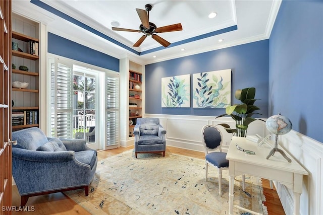 office featuring crown molding, wood finished floors, and a tray ceiling