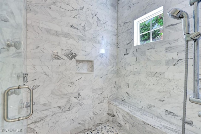 full bath with a marble finish shower