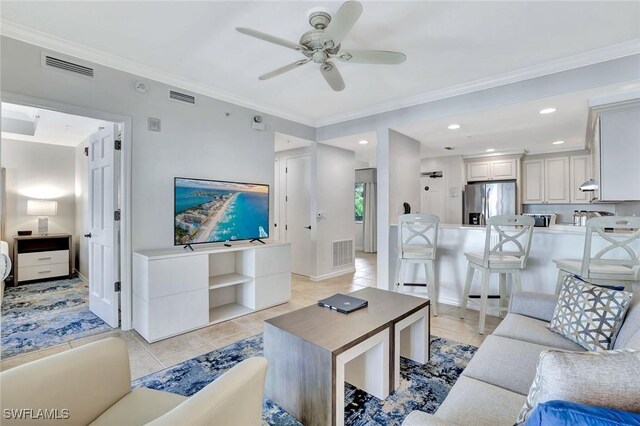 221 9th St S Unit 219, Naples, FL 34102 - living area with visible vents, a ceiling fan, light tile patterned floors, and ornamental molding
