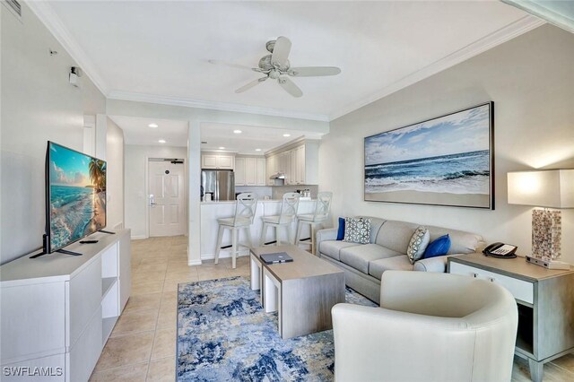 221 9th St S Unit 219, Naples, FL 34102 - living room with light tile patterned floors, ceiling fan, and ornamental molding