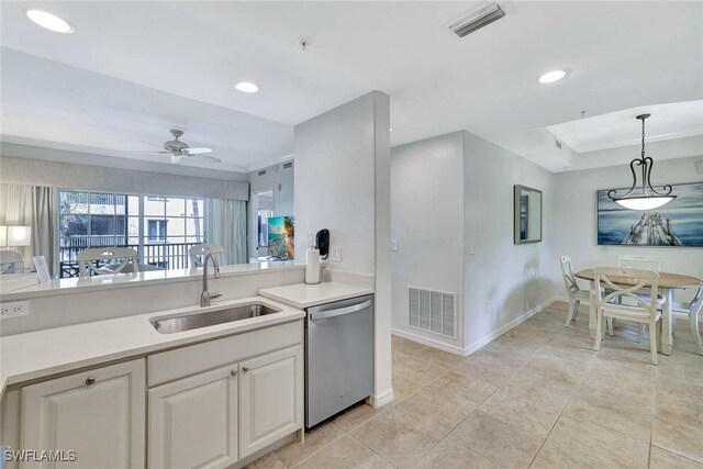 221 9th St S Unit 219, Naples, FL 34102 - kitchen with a sink, light countertops, baseboards, stainless steel dishwasher, and visible vents