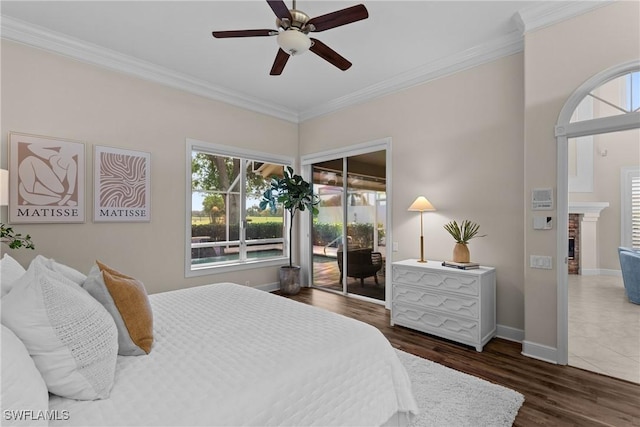 11476 Quail Village Way, Naples, FL 34119 - bedroom featuring ornamental molding, wood finished floors, a fireplace, a ceiling fan, and access to exterior