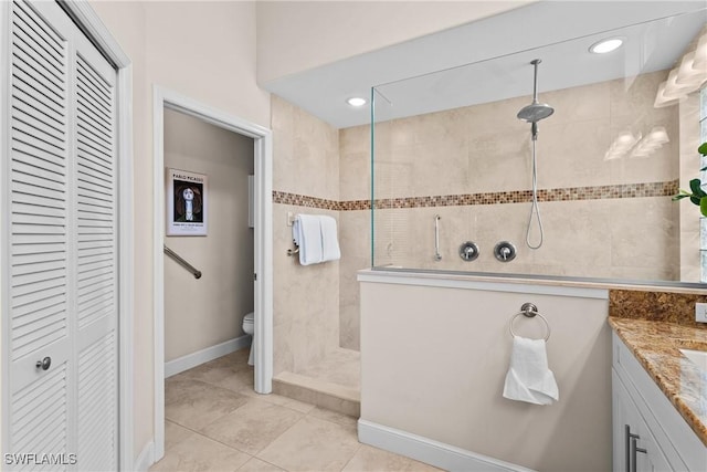 11476 Quail Village Way, Naples, FL 34119 - bathroom featuring a closet, a walk in shower, vanity, and tile patterned flooring