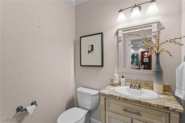 half bath featuring toilet and vanity