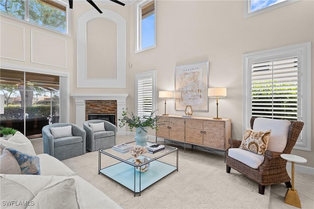 11476 Quail Village Way, Naples, FL 34119 - living area featuring a towering ceiling, ceiling fan, and a fireplace