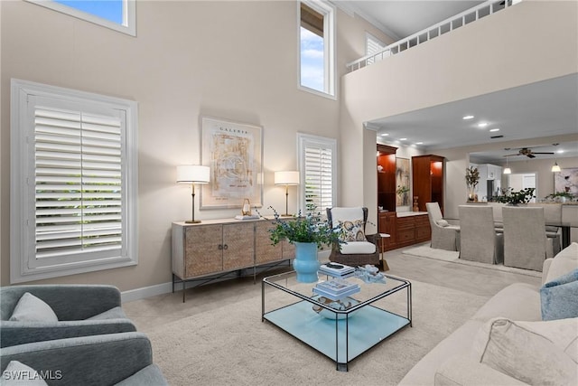 11476 Quail Village Way, Naples, FL 34119 - living area featuring ceiling fan, a towering ceiling, plenty of natural light, crown molding, and tile patterned flooring