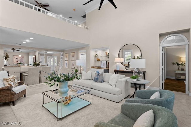 11476 Quail Village Way, Naples, FL 34119 - tiled living room with a ceiling fan, a high ceiling, plenty of natural light, ornamental molding, and recessed lighting