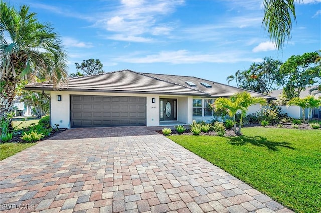 28389 Verde Ln, Bonita Springs, FL 34135 - ranch-style home with decorative driveway, a front lawn, stucco siding, and a garage