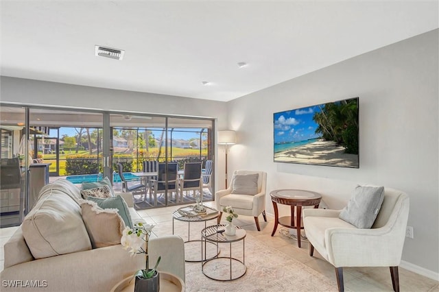 28389 Verde Ln, Bonita Springs, FL 34135 - living room featuring tile patterned flooring, baseboards, and plenty of natural light