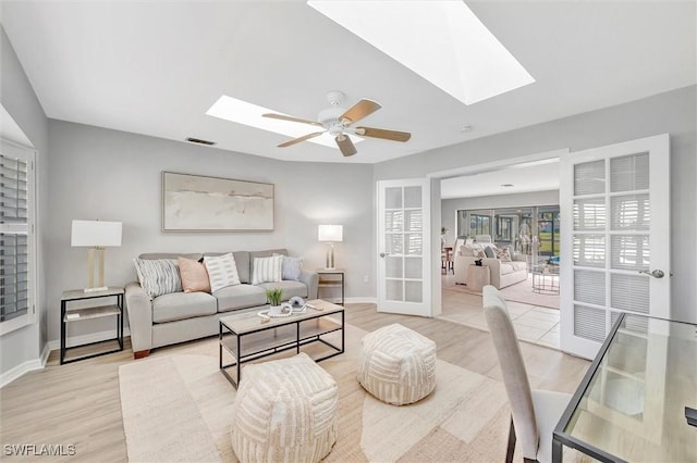 28389 Verde Ln, Bonita Springs, FL 34135 - living area with a skylight, light wood-type flooring, baseboards, and a ceiling fan